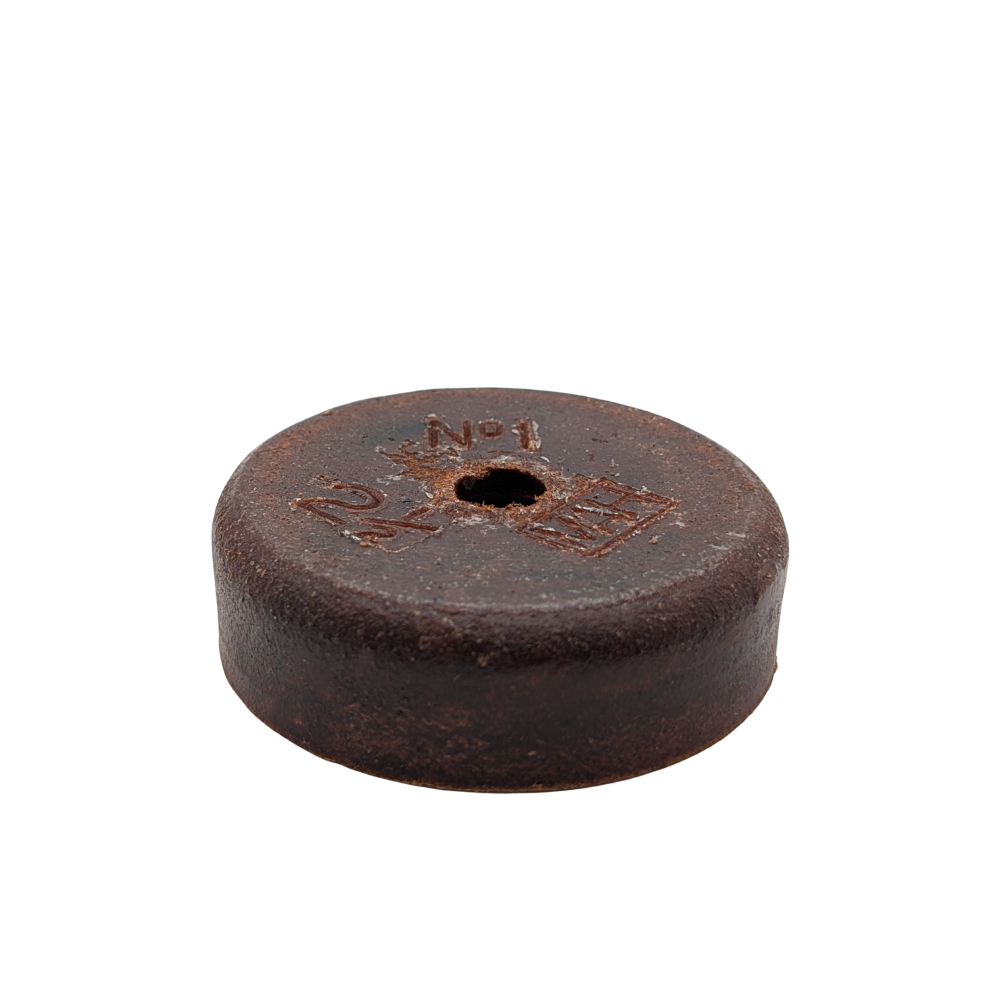 Round brown object with a central hole on a white background