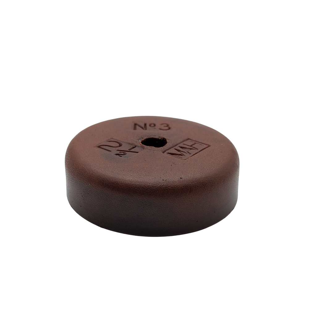 Brown round object with measurements on a white background